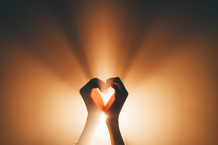 A symbolic image of faith, love and platonic pleasures. Hands forming a heart shape - stock photo