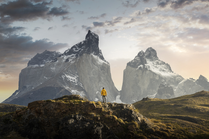 Hiker admiring the Cuernos del Paine range, Patagonia - stock photo