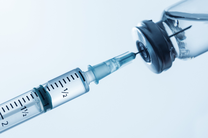 Hypodermic needle inside vaccine container