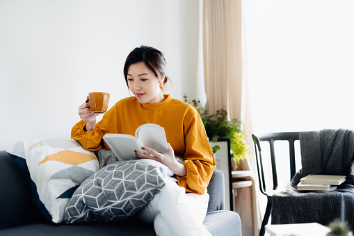 Woman reading book about the Science of Reading