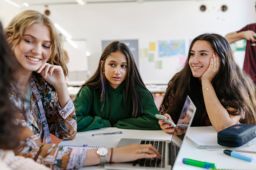 A group of students collaborating with one another