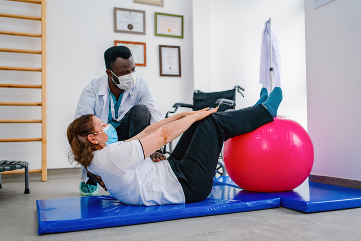 Sports Psychologists helping a person with exercise