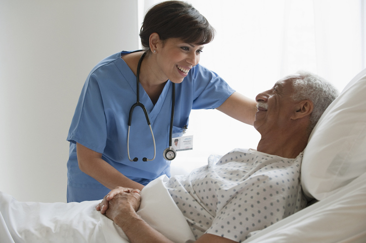 A hospitalist at bedside with patient