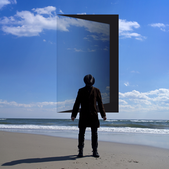 Man stands in front of the opened door in the sky. - stock photo