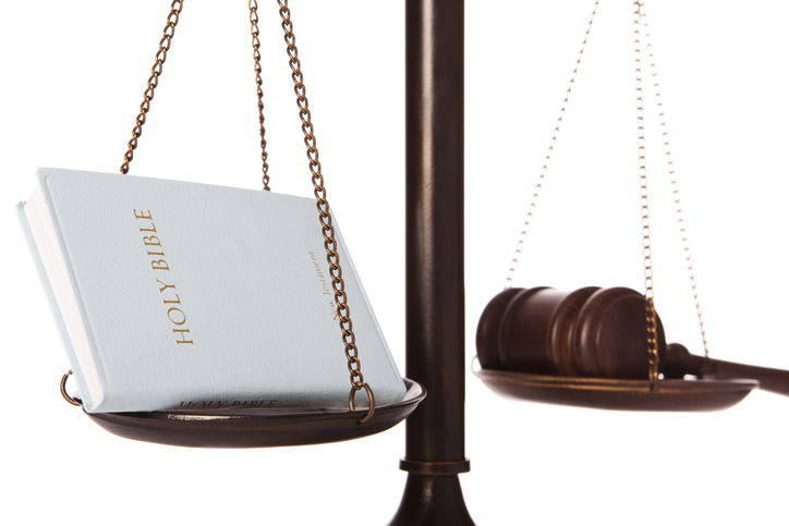 Bible and gavel on scale - stock photo