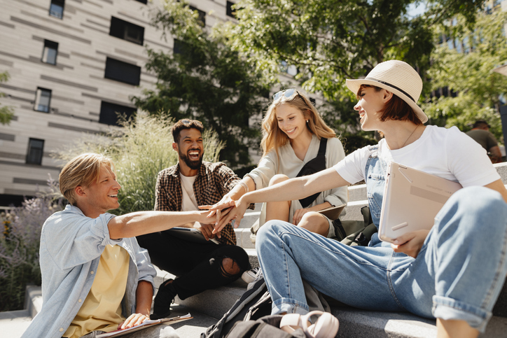 Group of students working ethically together on college campus.