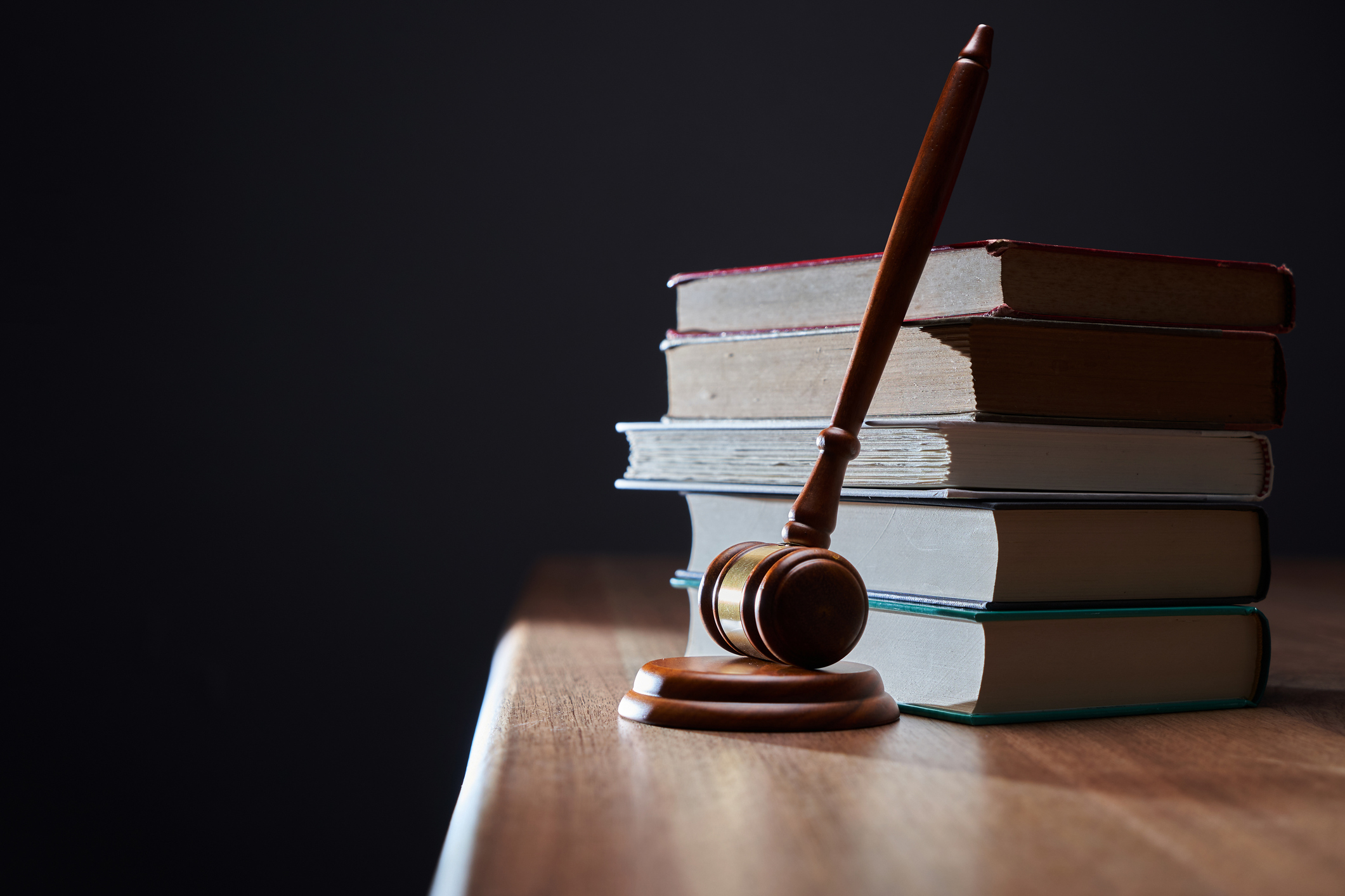 Gavel resting against book stack.