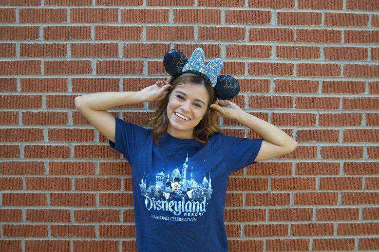 Student poses with Disneyland Resort shirt and Mickey Mouse ears on