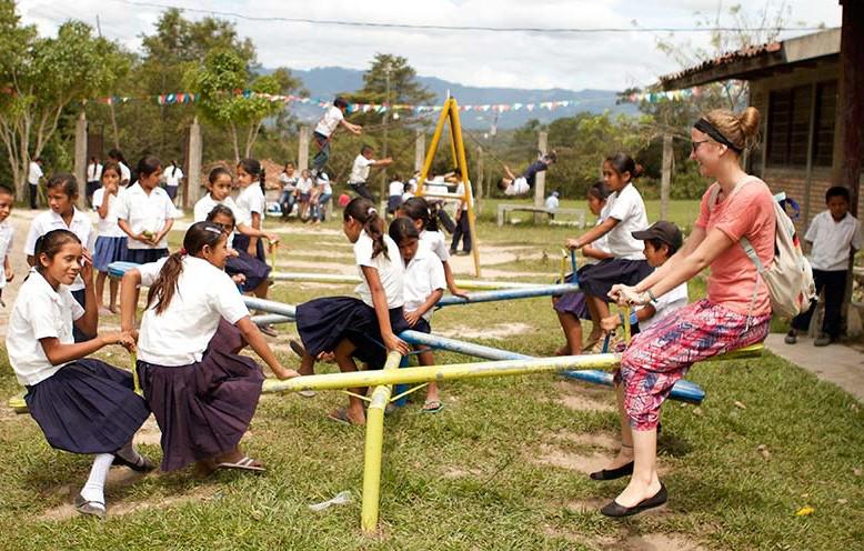 Children play outside in schoolyard setting