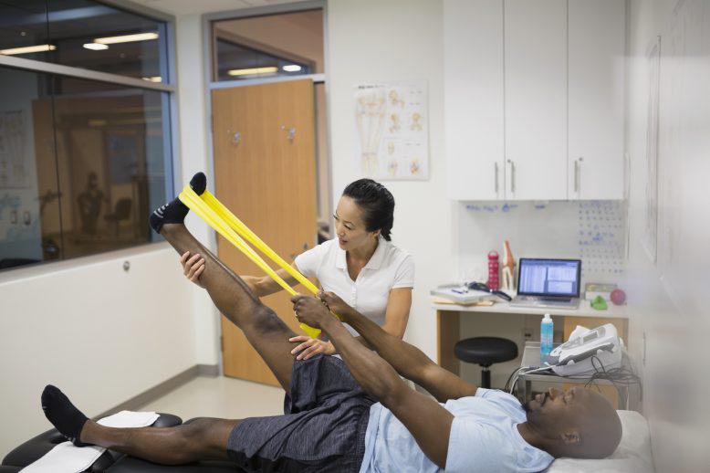 athletic trainer helping client