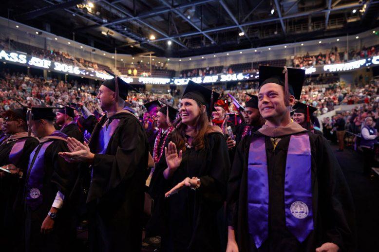 Group of excited honors college graduates at ceremony