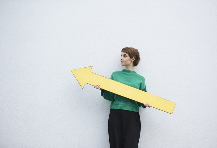 woman holding arrow upward