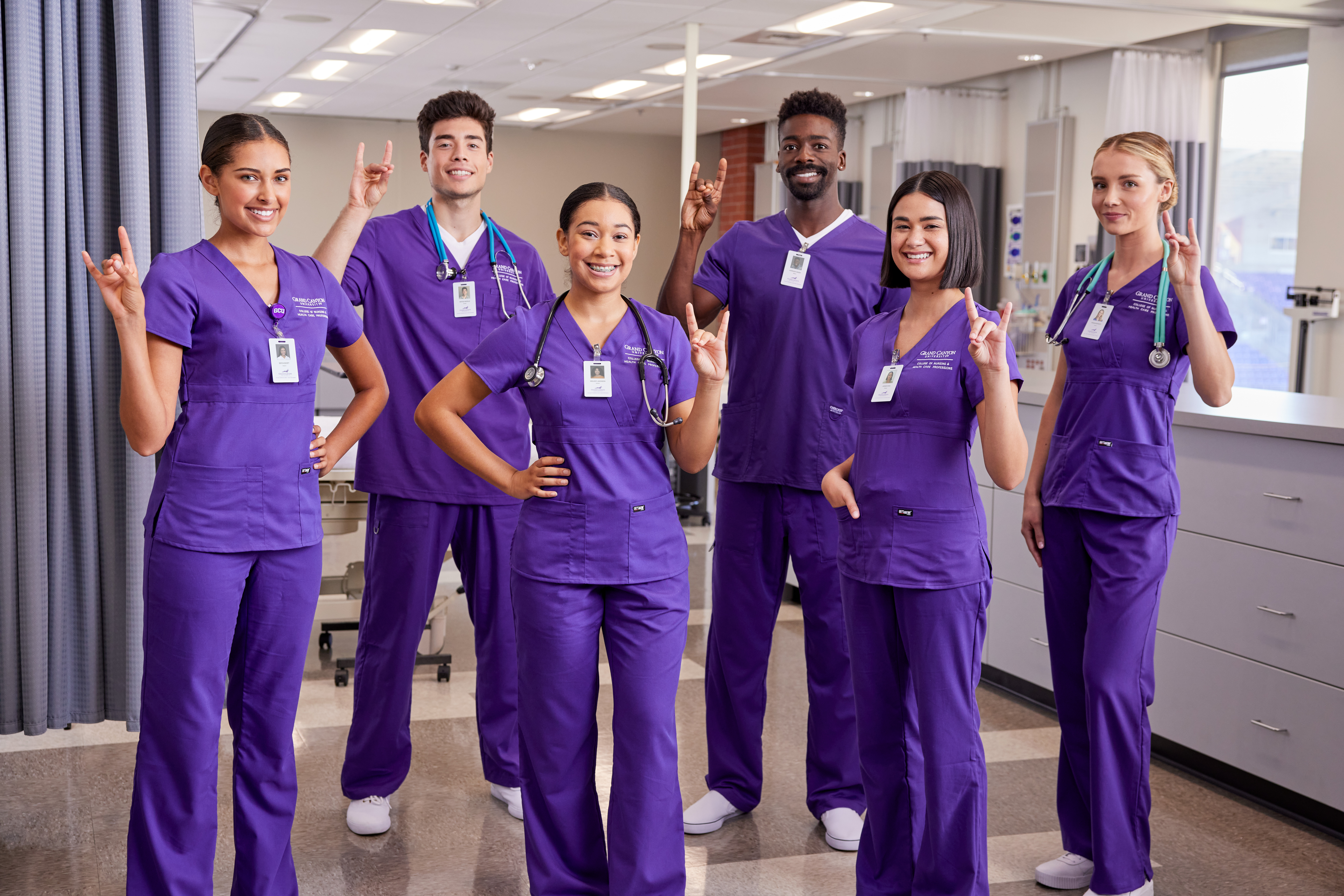 Male and female BSN degree students smiling in hospital on GCU's campus