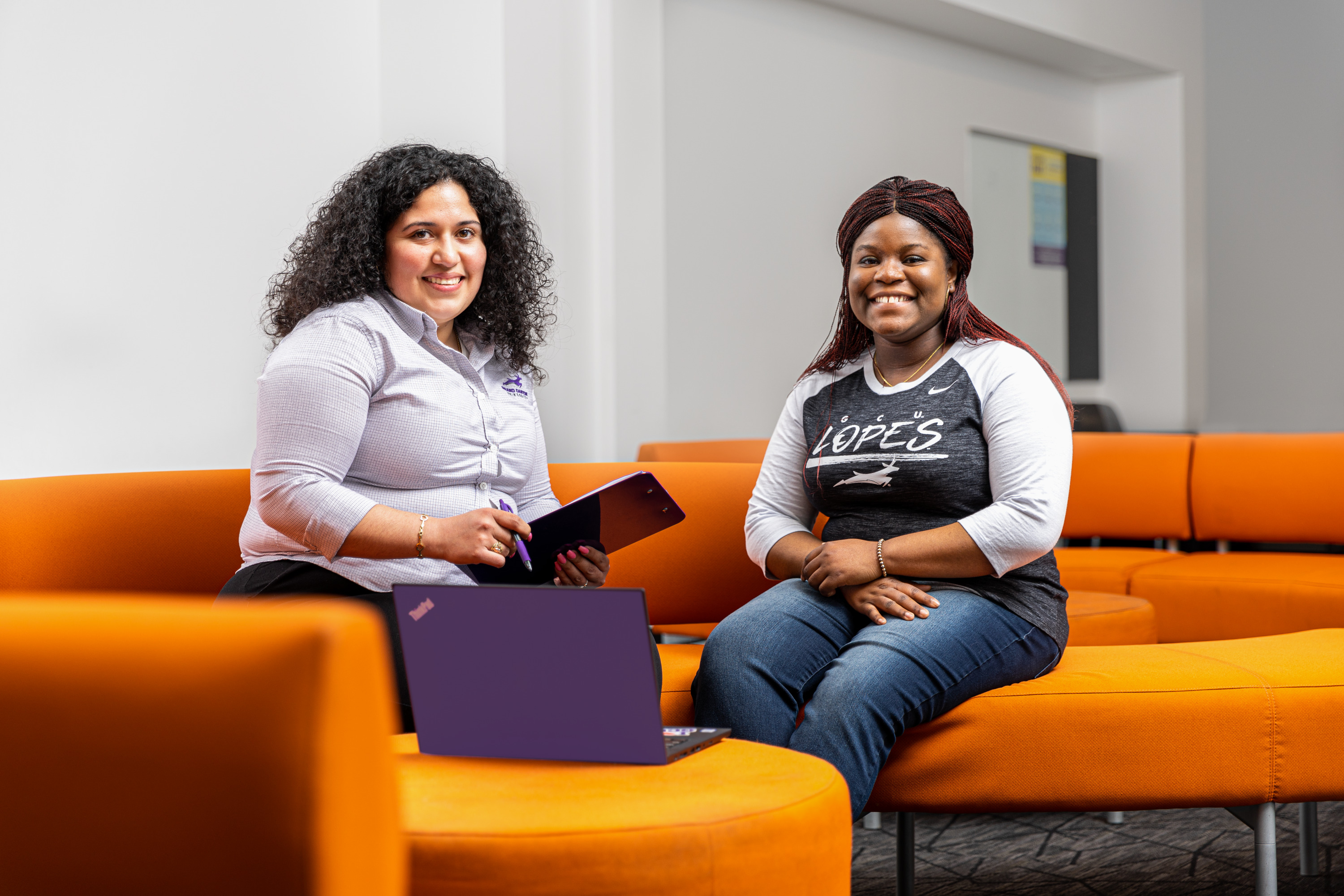 Female financial advisor meeting with GCU nursing student in office lounge