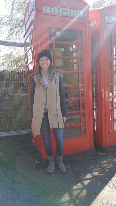 GCU Student Michele standing in front of phone booth in London