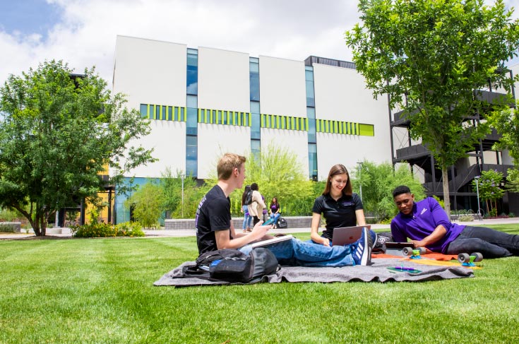 Honors students studying in front of the College of Business