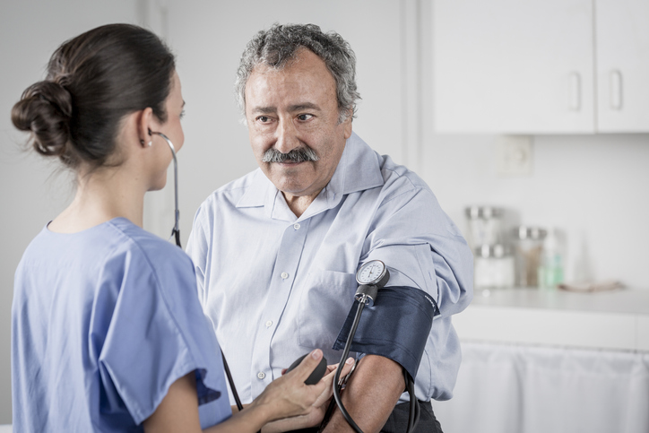 Nurse takes a patient's blood pressure