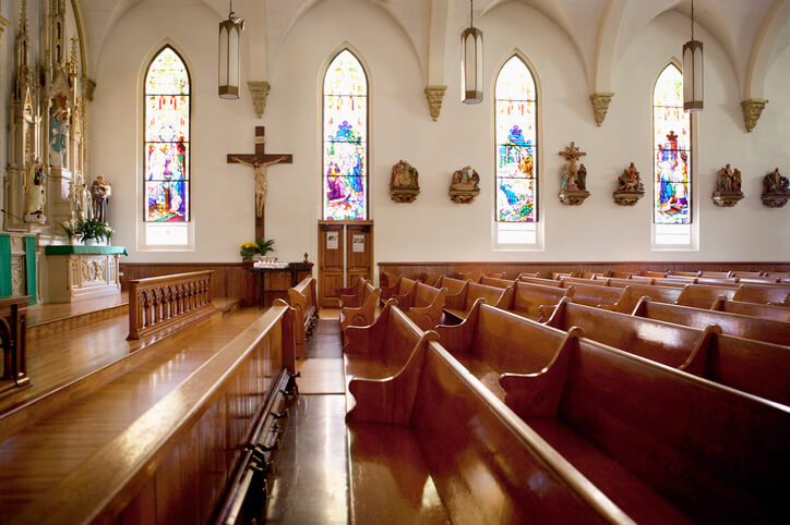 Pews and stained glass windows in church