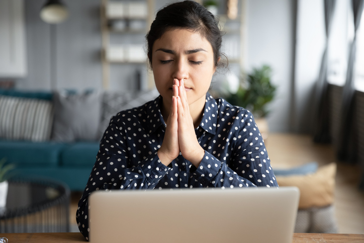 Woman prays at her workplace