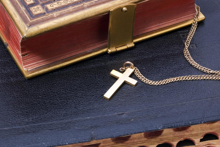 gold cross on bible 