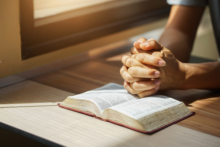 Man reading his Bible at his desk