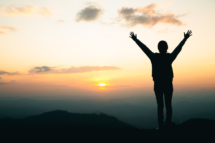 woman praying on the mountain